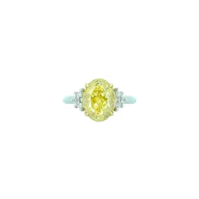 18 Karat White and Yellow Gold Three Stone Ring with Oval Cut Fancy Yellow Diamond and white Half moon diamonds